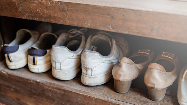 The old shoe rack in the house is a shoe rack with a wooden surface.