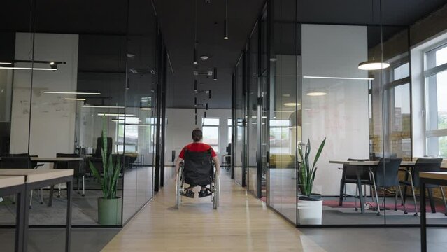 A young female entrepreneur, using a wheelchair due to her condition, navigates through modern, inclusive offices, showcasing determination and empowerment in the workplace.