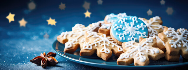 Obraz na płótnie Canvas Christmas cookies on a plate against a blue background