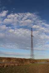 A tall metal tower in a field