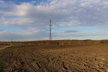 A large field with a tower in the distance