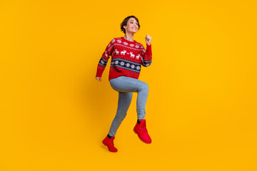 Fototapeta na wymiar Full body photo of excited gorgeous woman wear red sweater run shopping look at sale empty space isolated on yellow color background