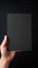 a black square on a white background with a hand holding it. AI generated