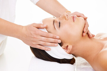 Spa, hands and face massage with a woman customer in studio isolated on a white background for...