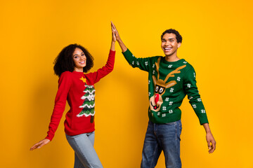 Photo of charming excited guy girl dressed christmas ugly print pullovers rising palms high five...