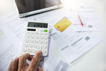 Small business owner calculate expenses paid via credit card and checking receipt and purchase order after starting a new business online