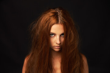 Naklejka premium Depression, portrait or woman in studio with trauma stress, fail or bad results on mockup space alone. Black background, psychology or face of serious person with anger, messy hair or moody attitude