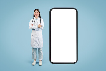 Woman doctor standing near big blank phone with empty screen