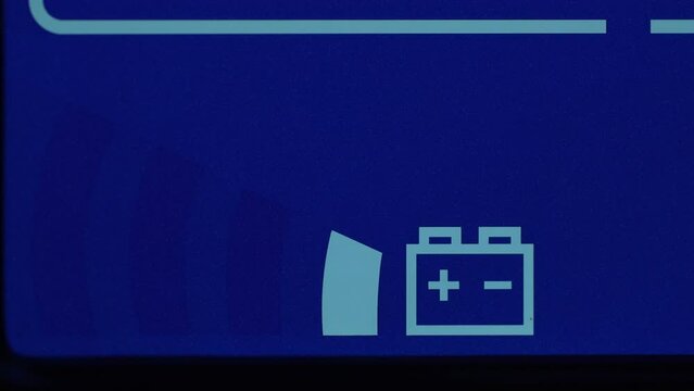 Close up of blue digital display on uninterruptible power supply with automatic voltage stabilizer