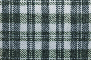 Tartan pattern on a wool fabric in green and white