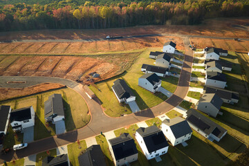 Aerial view of real estate development with tightly located family houses under construction in...