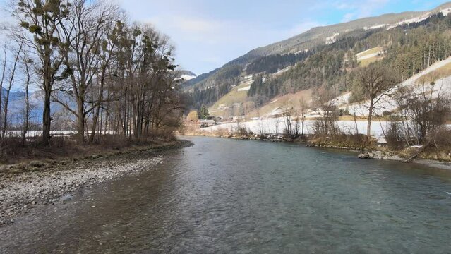 Aerial view of the Ziller river on a winter day surrounded by mountains, Fuegen Tyrol, Austria.