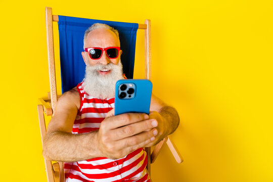 Close up portrait of carefree resort party pensioner grandfather wear sunglasses blogging photographing isolated on yellow color background