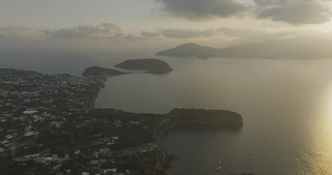 Aerial view of Cala del Vecchio Pozzo, a small bay with high cliffs on the Procida island at sunset, Flegree Islands archipelagos, Naples, Campania, Italy.
