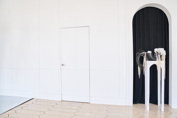 Wooden white door on a light background. Creative idea of a closed door, an entrance doorway, next...