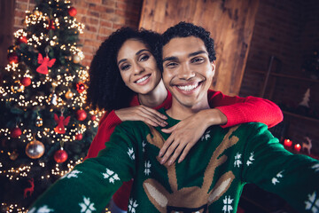 Selfie photo of best friends guy lady cuddle blogging party on christmas holiday in decorated lights house indoors