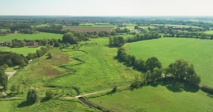 Aerial view of small meandering river Swalm in stream valley Swalmdal and farms at the countryside, Swalmen, Limburg, Netherlands.