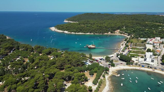 Aerial view of a narrow inlet with turquoise water and sailing boats along the coastline, Pula, Istria, Croatia.