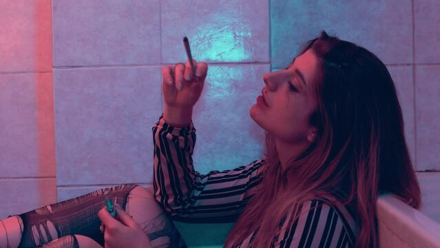 problems, depression - stoned girl in torn pantyhose smokes a joint of weed