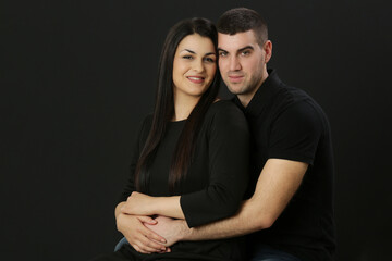 Studio portrait of young couple on the black background