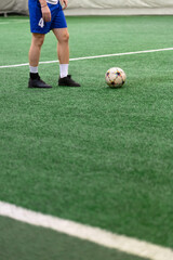 Ball and arena soccer player on the field during the game.