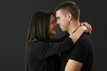 Studio portrait of young couple on the black background