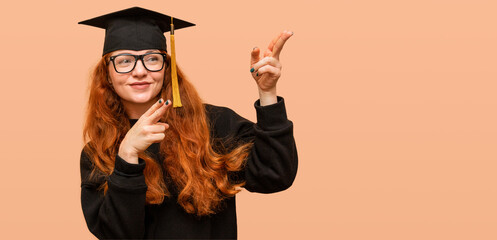 Young woman wearing glasses, she is a graduate student, and points her fingers towards the empty...