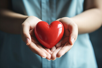 Woman holding red heart in hands, closeup. Charity and donation concept