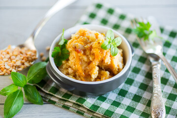 Cooked pea porridge with spices and seasonings in a ceramic bowl .