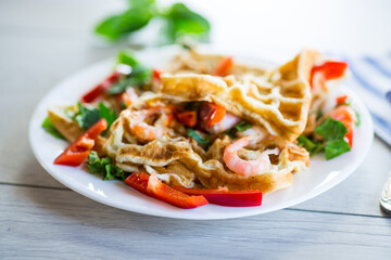 Fried simple omelet with shrimp and vegetables in a plate.