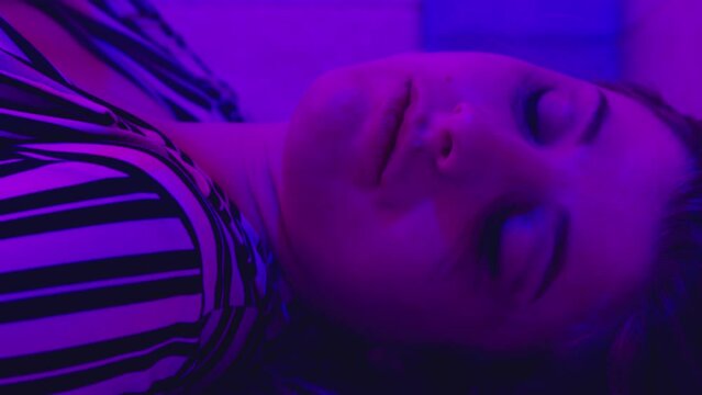 drug effects - girl smoking a joint stares at camera with catatonic gaze - macro