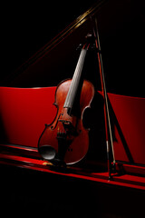 Violin and music. Classic Violin on a red piano. Viola or fiddle on piano notes. Music concept....