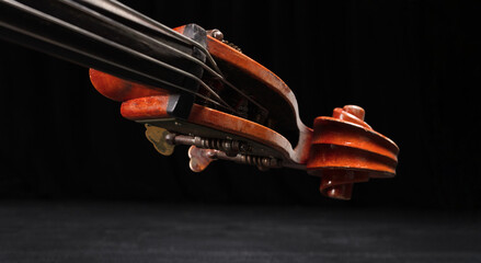 Vintage Double bass head with stock with strings and tuners, music concept. Close up.  Shallow depth of field