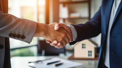 Two businessmen shaking hands after a real estate deal. - obrazy, fototapety, plakaty