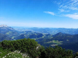 the village nestles in the mountain range under a blue sky