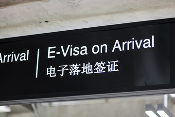 Electronic Visa on arrival signage concept at airport for tourists. Visa sign in English and Chinese in airport