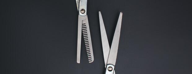 Professional Haircutting Scissors. Open hairdresser scissors on a black background. Professional...