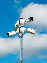 Pole with four outdoor security CCTV cameras or surveillance system for monitoring the surroundings