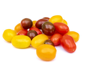 Different sorts of tomatoes isolated on white background.
Fresh, ripe type of small and round cocktail tomatoes, of red, yellow and orange color. Solanum lycopersicum var. cerasiforme. 