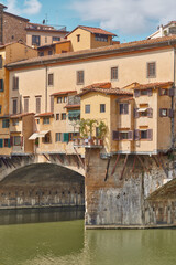 Fototapeta na wymiar Ponte Vecchio, vertical close-up of the goldsmiths' shops and Arno river