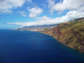 Fototapeta premium Portugal, Madeira Island, aerial view on cliffs and Funchal town from drone