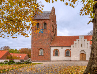 church walk with  fallen leaves leading upp to Helsinge church