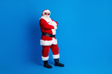 Full length photo of mature pensioner man crossed arms promotion dressed stylish santa claus costume coat isolated on blue color background