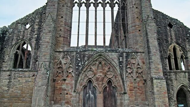 Ruins of the National Icon Monastery of Tintern Abbey in Wales. Ruins of a Cistercian abbey with Gothic West Front and a gift shop  in the village of Tintern in Monmouthshire, Wales
