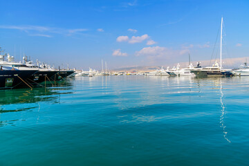 Boats along the waterfront promenade at the Athenian Riviera's Flisvos Marina in Palaio Faliro, Greece. - obrazy, fototapety, plakaty