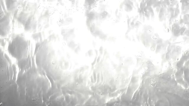 Pure beige water with reflections sunlight in slow motion. Water surface texture top view. Sun and shadows. Motion clean swimming pool ripples and wave, 2.7 k.