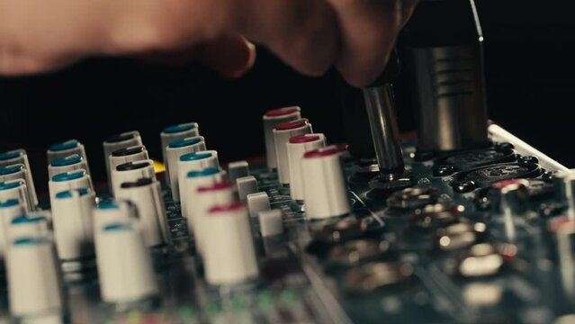 Soundboard pads station close-up. Sound designer use digital audio mixer in production studio. Sound engineer sliders in radio station. Engineer press key buttons control desk recording TV studio