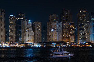 Obraz premium View of modern skyscrapers in Jumeirah beach residence on November in Dubai, JBR - artificial canal city, carved along a 3 km stretch of Persian Gulf shoreline.
