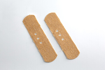 Band-Aids on a white background. Punctuation double slash made with two band-aids.