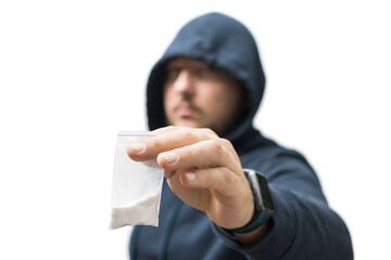 Criminal man in a hood holds transparent plastic bag with white powder hard drugs isolated on white background, drug dealer or gangster sells narcotics - obrazy, fototapety, plakaty